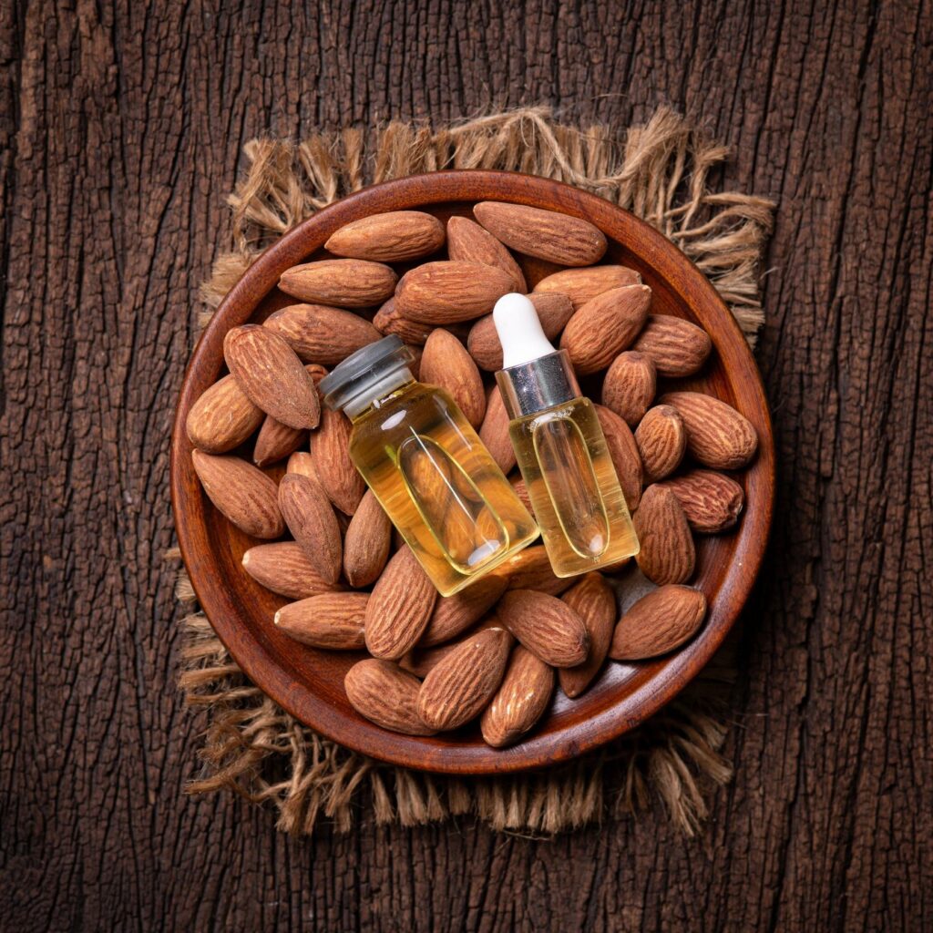 Almond essential oil on a wooden surface